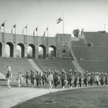 Band marching in Coliseum, 1950's