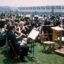 Wind Ensemble performing outdoors on campus, 1970