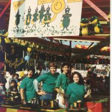 Larry Stern, Shawn Benham, Valda Vitols and Sarah Weinstein running the Mardi Gras Band Booth, mid 1980's
