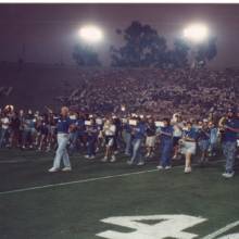 Drum Major Ed Peatross leads the Alumni across the field on "Sons of Westwood," 1996 Band Alumni Reunion