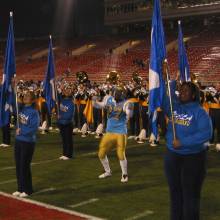 Tailback Akil Harris dancing with flag after game, 2002 Las Vegas Bowl, December 25, 2002