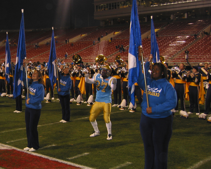 Tailback Akil Harris dancing with flag after game, 2002 Las Vegas Bowl, December 25, 2002