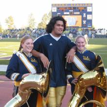 Tubas with UCLA football player in Husky Stadium, Washington game, November 2, 2002