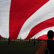 Holding up the giant U.S. Flag