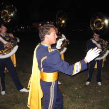 Sousaphone Section Leader Chris Bald leading the warmup before the Chino show