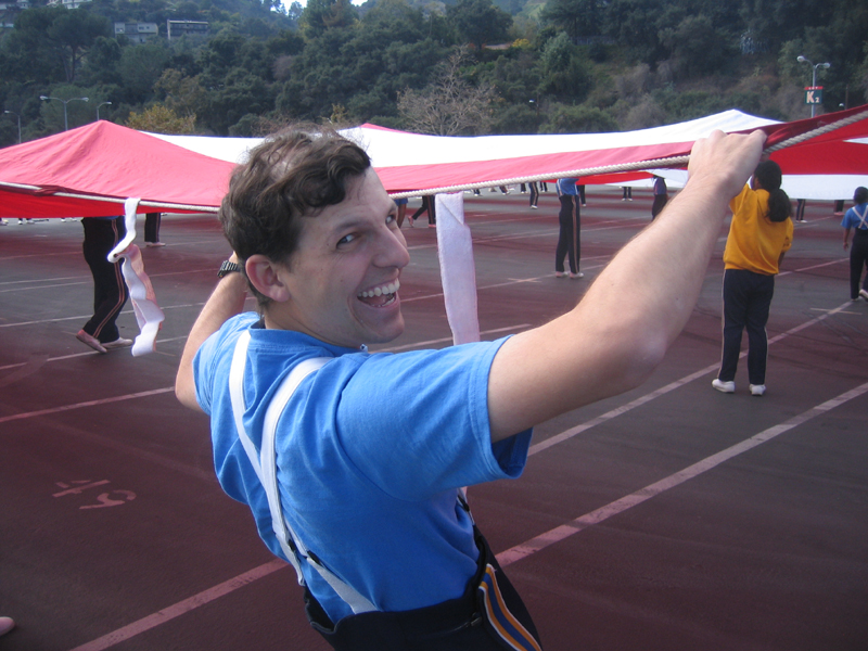 Matt Silverman holding flag at rehearsal