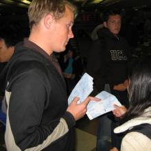 Drum Major Sean Garnreiter hands out airline tickets, Notre Dame trip 2006