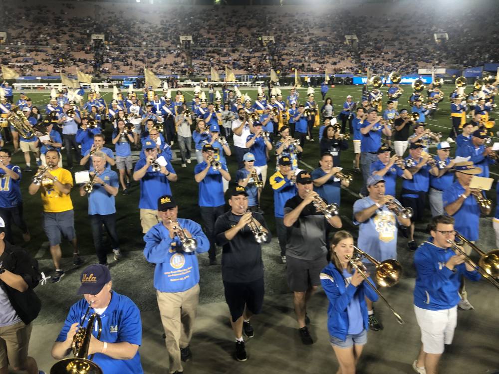 Band Alumni marching off the field