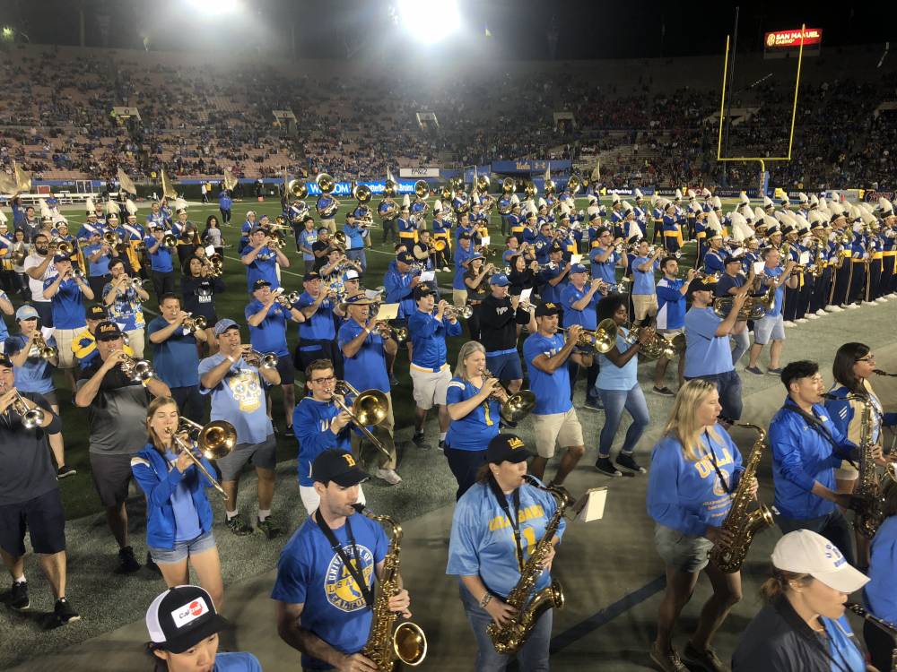 Band Alumni marching off the field