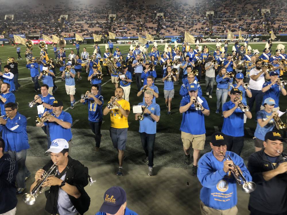 Band Alumni marching off the field