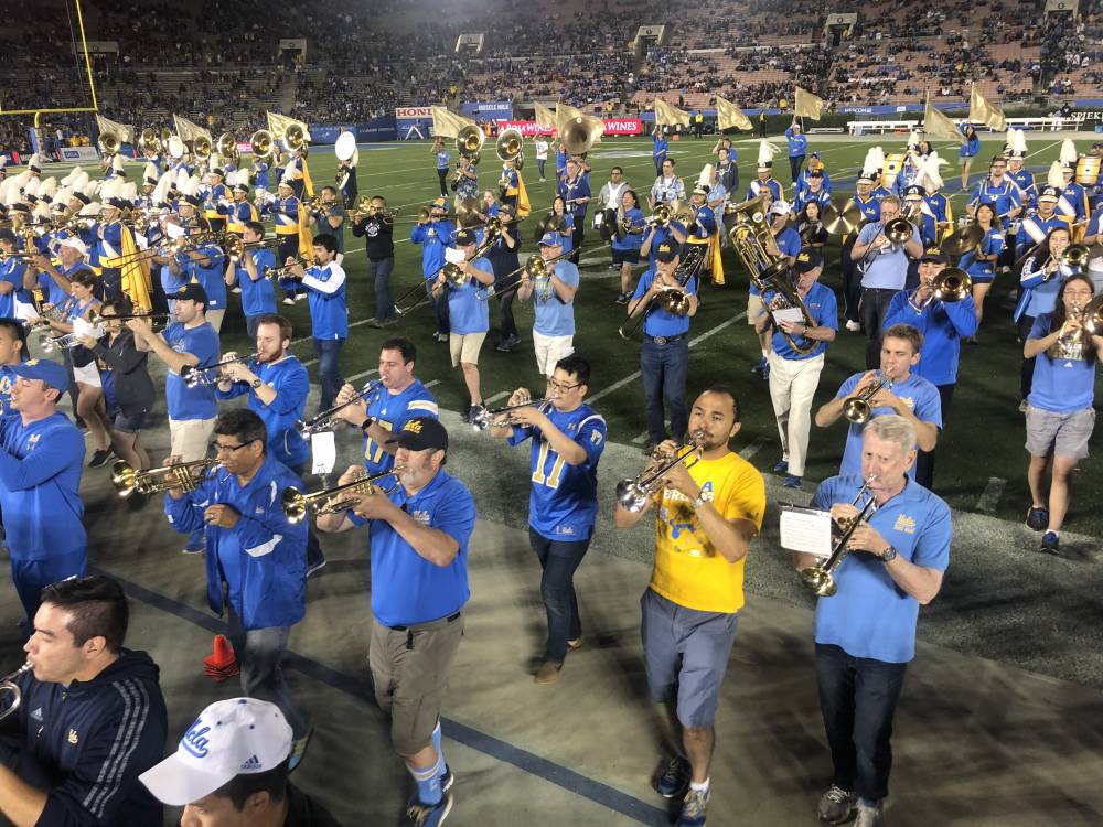 Band Alumni marching off the field