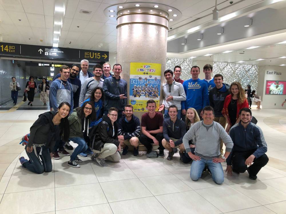 The full group, along with our hosts, pose around one of the posters in the underground mall near to our hotel