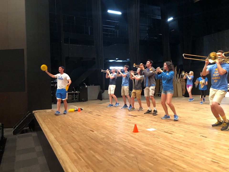 Practicing the Frisbee tosses in rehearsal at the Winc Theater