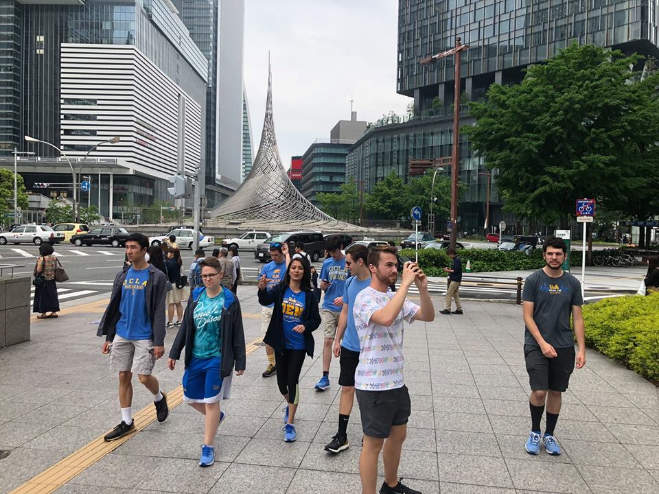 Sightseeing in Nagoya. In the background is the stainless steel sculpture in front of the Nagoya Train Station called the Monument Hisho