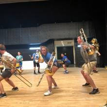 Trombonists Simon Kapler, Lily Krol, Chris Routh and Sukhi Bassi rehearsing "Wipeout" at the Winc Theater